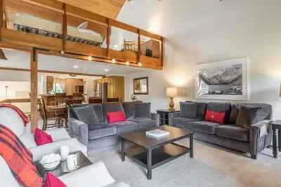 a living room with couches and a dining room at Snowcreek IV 549 in Mammoth Lakes