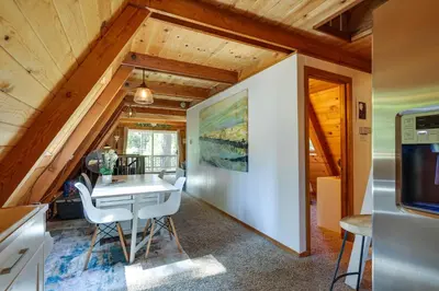 a kitchen and dining room with a table and chairs at Decks, Grills and Fire Pit Camp Connell Hideaway! in Camp Connell