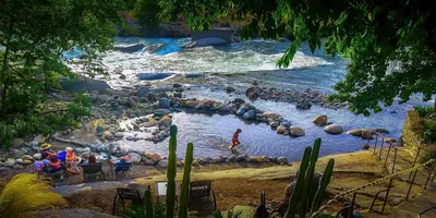 a river with a group of people in the water at Birdwatch Cottage With River Beach Pass in Three Rivers