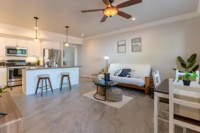 a living room and kitchen with a ceiling fan at Boho Townhome in Carson City 10 Mins From Downtown, 30 Mins To Lake Tahoe in Carson City