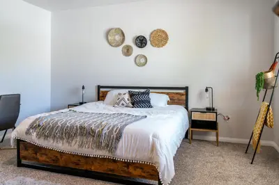 a bedroom with a large bed with pillows on it at Boho Townhome in Carson City 10 Mins From Downtown, 30 Mins To Lake Tahoe in Carson City