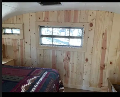 a room with a wooden wall with a window at Glamping property in Panorama Heights