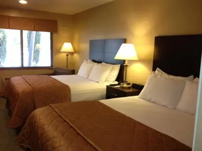 a hotel room with two beds and a window at Casa de Fruta Cabins, Inn & RV Park in Hollister