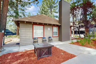 a small house with two chairs and a table in front of it at Manzanita Holiday 3 in South Lake Tahoe