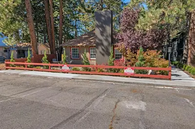 a house with a fence on the side of a street at Manzanita Holiday 3 in South Lake Tahoe