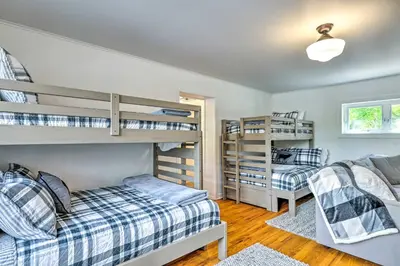 a bedroom with two bunk beds and a couch at Steps to Dtwn Murphys Cottage with Furnished Porch in Murphys