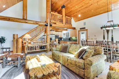 a living room with a couch and a table at 2 Cabins Group and Family Getaway in Arnold! in Arnold