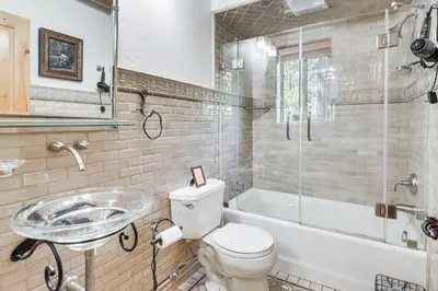 a bathroom with a toilet and a sink and a tub at 2 Cabins Group and Family Getaway in Arnold! in Arnold