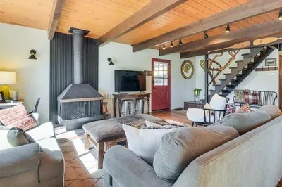 a living room with a couch and a fireplace at 2 Cabins Group and Family Getaway in Arnold! in Arnold