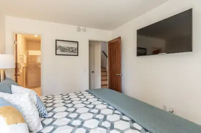 a bedroom with a bed and a television on the wall at Chamonix 24 is a 2bed plus loft 3 bath Upgraded Canyon Ldge Nearly Ski in Ski Out Sleeps 8 in Mammoth Lakes