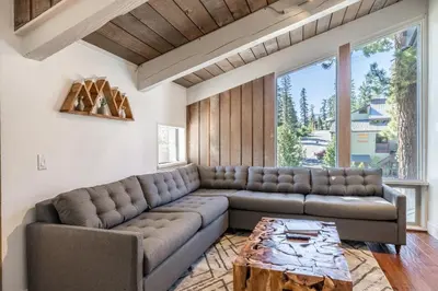a living room with a couch and a table at Chamonix 24 is a 2bed plus loft 3 bath Upgraded Canyon Ldge Nearly Ski in Ski Out Sleeps 8 in Mammoth Lakes