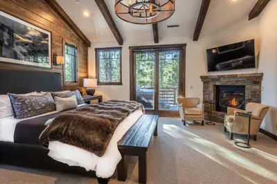 a bedroom with a large bed and a fireplace at Gray Bear #86 home in Mammoth Lakes