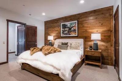 a cat laying on a bed in a bedroom at Gray Bear #86 home in Mammoth Lakes