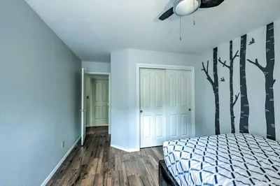 a bedroom with a bed and trees on the wall at Charming Home Less Than 10 Mi to Sequoia Natl Park! in Three Rivers
