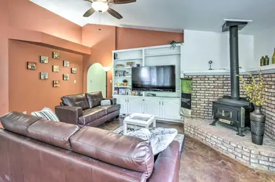 a living room with a leather couch and a fireplace at Charming Home Less Than 10 Mi to Sequoia Natl Park! in Three Rivers
