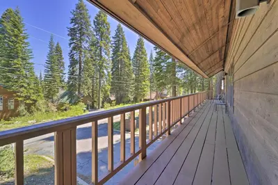 a wooden balcony with a view of trees at Wraparound Deck and Pool Access Truckee Cabin in Truckee