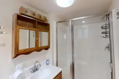 a bathroom with a shower and a sink at Lakefront Retreat in Bass Lake