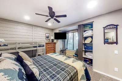 a bedroom with a bed and a ceiling fan at Huntington Lake Condo #102 in Lakeshore