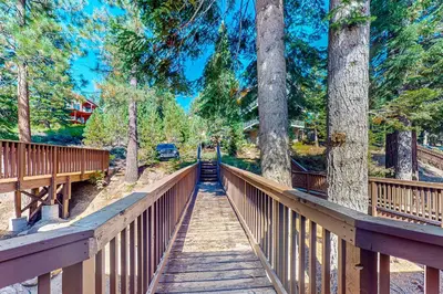 a wooden bridge in a park with trees at Huntington Lake Condo #102 in Lakeshore