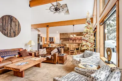 a living room with couches and a christmas tree at 17th Tee Lake Tahoe Retreat in Incline Village
