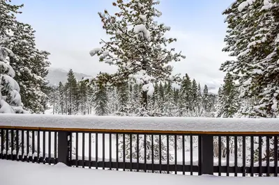 a wooden fence covered in snow with trees at 17th Tee Lake Tahoe Retreat in Incline Village