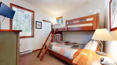 a bedroom with two bunk beds and a desk at Eagle Run #114 condo in Mammoth Lakes