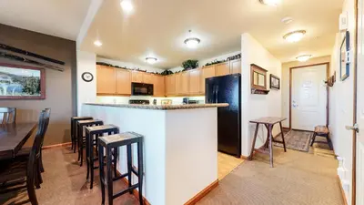 a kitchen and dining room with a bar and a table at Eagle Run #114 condo in Mammoth Lakes