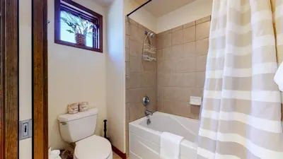 a bathroom with a toilet and a tub and a shower at Eagle Run #114 condo in Mammoth Lakes