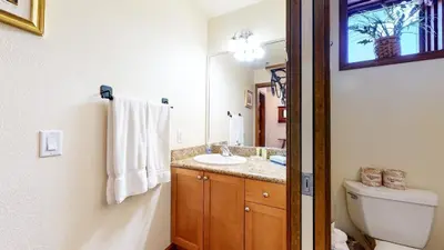 a bathroom with a sink and a toilet and a mirror at Eagle Run #114 condo in Mammoth Lakes