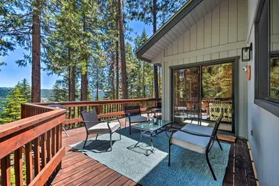 a deck with chairs and tables on a house at Hike, Fish, and Relax Family Arnold Cabin in Arnold