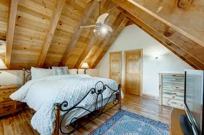 a bedroom with a bed and a wooden ceiling at Toast of the Mountain Town in Truckee