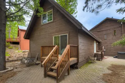 a house with a porch and a deck at Toast of the Mountain Town in Truckee