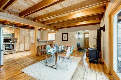 a kitchen and dining room with a table and chairs at Toast of the Mountain Town in Truckee