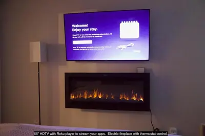 a flat screen tv above a fireplace in a room at St Anton Condos #77 condo in Mammoth Lakes