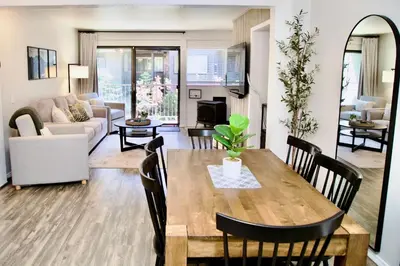 a living room with a wooden table and chairs at St Anton Condos #77 condo in Mammoth Lakes