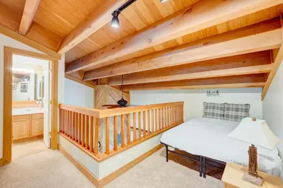 a bedroom with wooden ceilings and a bed in a room at Pine Time in Truckee