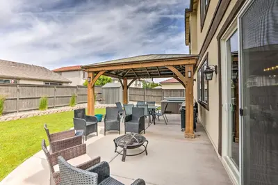 a patio with chairs and a table and a grill at Air Racing Decor, Hot Tub Sparks Home! in Sparks