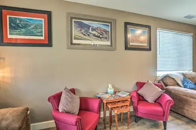 a living room with two chairs and a table at Air Racing Decor, Hot Tub Sparks Home! in Sparks