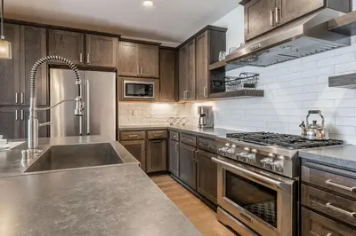 a kitchen with stainless steel appliances and wooden cabinets at Creekhouse 1334 in Mammoth Lakes