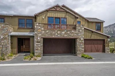 a house with two garage doors and a balcony at Creekhouse 1334 in Mammoth Lakes