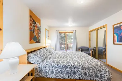 a bedroom with a bed and a desk and a window at Less Than 8 Mi to Donner Lake Home with Deck and Balcony! in Truckee