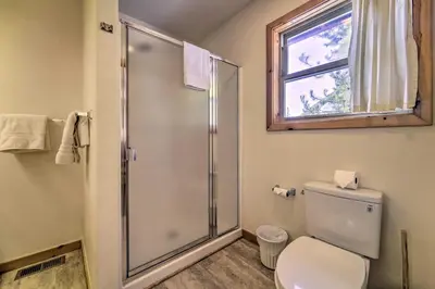 a bathroom with a shower and a toilet and a window at Less Than 8 Mi to Donner Lake Home with Deck and Balcony! in Truckee
