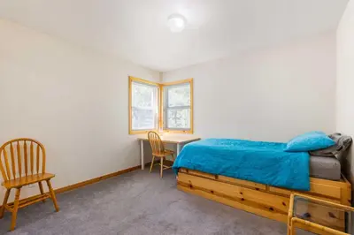 a bedroom with a bed and a desk and chairs at Less Than 8 Mi to Donner Lake Home with Deck and Balcony! in Truckee