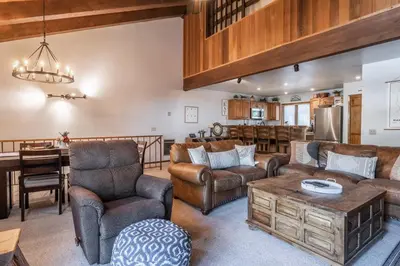 a living room with leather furniture and a table at Mammoth Pines #7 Newly updated 2 Bedroom plus Loft, 3 Full Bathrooms, Sleeps 8 people in Mammoth Lakes