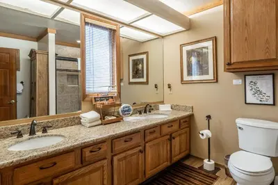 a bathroom with a sink and a toilet and a window at Mammoth Pines #7 Newly updated 2 Bedroom plus Loft, 3 Full Bathrooms, Sleeps 8 people in Mammoth Lakes