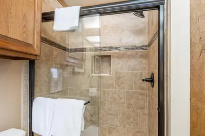 a bathroom with a shower with a glass door at Mammoth Pines #7 Newly updated 2 Bedroom plus Loft, 3 Full Bathrooms, Sleeps 8 people in Mammoth Lakes