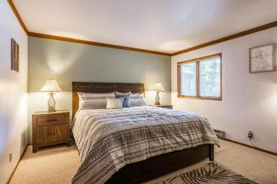 a bedroom with a large bed and two lamps at Mammoth Pines #7 Newly updated 2 Bedroom plus Loft, 3 Full Bathrooms, Sleeps 8 people in Mammoth Lakes