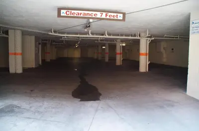 an empty parking garage with a sign that reads clearance feet at Mountainback 100 in Mammoth Lakes