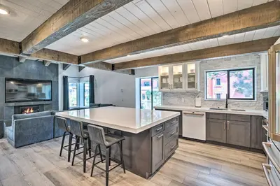 a kitchen with a large island with stools at Luxe Mountain Home in Village, Steps to Gondola! in Mammoth Lakes