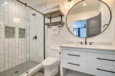 a bathroom with a shower and a toilet and a mirror at Luxe Mountain Home in Village, Steps to Gondola! in Mammoth Lakes